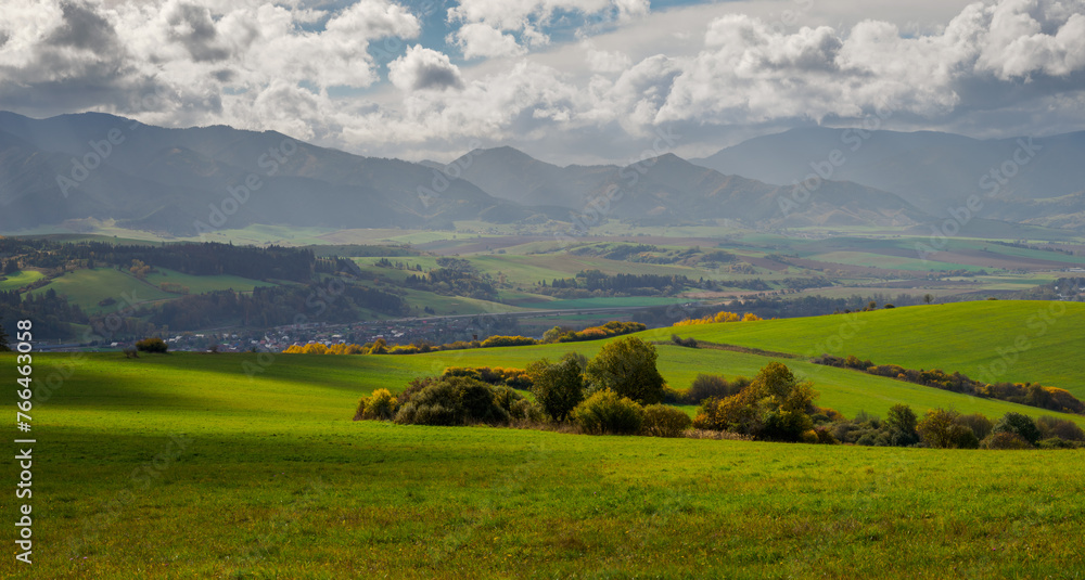 Mountain landscape. In the foreground, a farmland and autumn trees. In the distance you can see the Low Tatras Zilina Region. Beszeniowa. Slovakia. Mountain landscape. In the foreground, a farmland and autumn trees. In the distance you can see the Low Tatras Zilina Region. Beszeniowa. Slovakia.