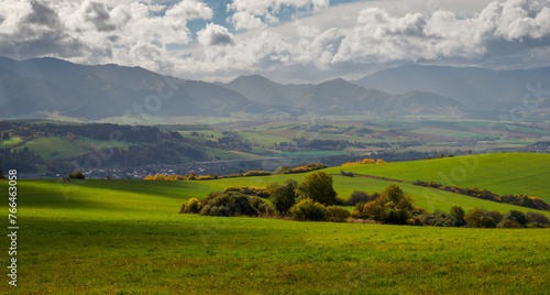 Mountain landscape. In the foreground, a farmland and autumn trees. In the distance you can see the Low Tatras Zilina Region. Beszeniowa. Slovakia. © AM Boro