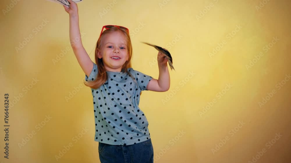 Child Cash Stack A little girl gleefully holding a handful of cash. Smiling child ...