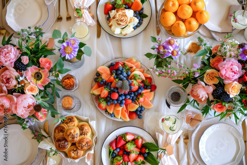 A beautifully set table brunch spread, complete with colorful floral arrangements, fresh fruits, and pastries, celebrate and cherish the special occasion.