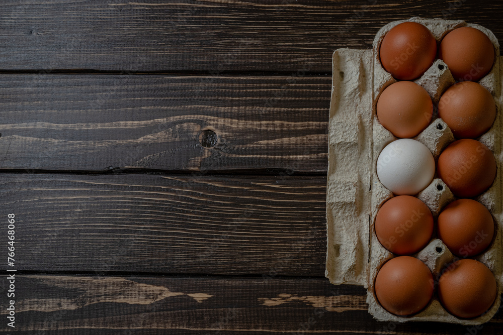 Fresh chicken eggs in a paper tray on the table, selective focus Fresh chicken eggs in a paper tray on the table, selective focus