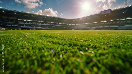 A Lush green soccer field in a stadium basked in sunlight