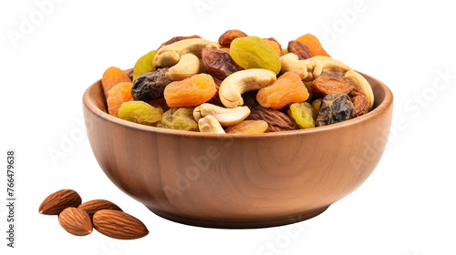An assortment of nuts and raisins spilling out from a rustic wooden bowl