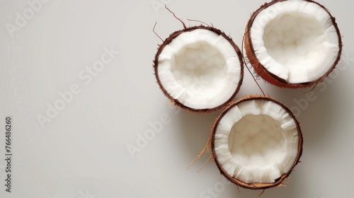 Two coconuts placed on a table, suitable for tropical themes