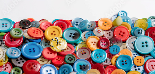 Assorted colorful buttons in a pile, isolated on white background, blank label. photo