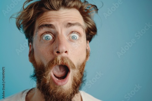 Close up of a person with a surprised expression. Perfect for illustrating shock or disbelief photo