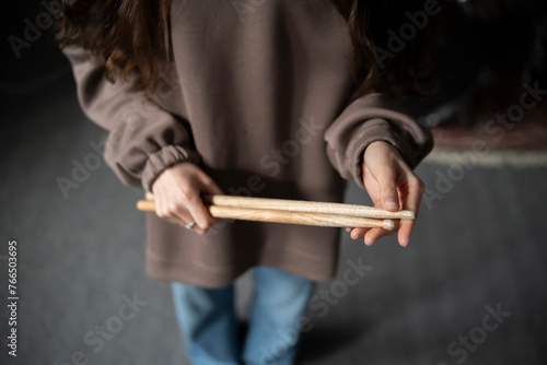 Drummer hands Holding Drumsticks While Standing in a Rehearsal Studio