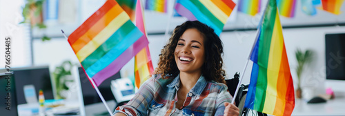 Happy disabled gay lesbian woman in wheelchair celebrating pride in LGBTQ+ friendly office with rainbow flags. Inclusive & diverse deib workplace equality representation & acceptance. Copy space