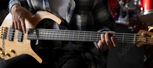 Close-Up View of a Musician Playing a Bass Guitar During an Indoor Session