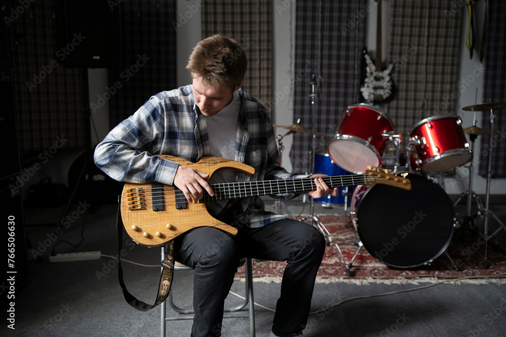 Casual Guitar Session in a Home Music Studio During Daytime, male person play guitar and sing song Casual Guitar Session in a Home Music Studio During Daytime, male person play guitar and sing song