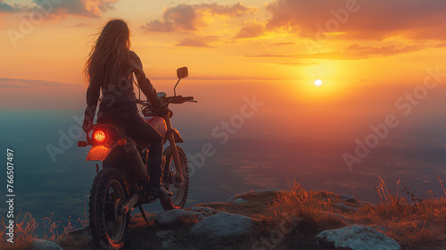 Motorcycle driver with her motorcycle in the sunset. Travel and sport, speed and freedom concept