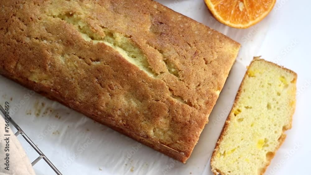 Slicing the loaf of Orange pound cake, also known as citrus loaf cake or orange butter cake Slicing the loaf of Orange pound cake, also known as citrus loaf cake or orange butter cake