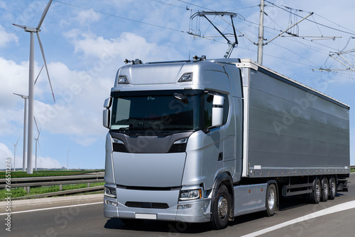 Electric semi truck with pantograph takes energy from wires above the highway
