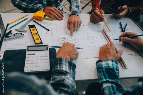 engineer people meeting working and pointing at a drawings in office for discussing. Engineering tools and construction concept.