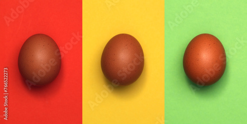Easter eggs on colorful papers. Easter holiday background concept.
