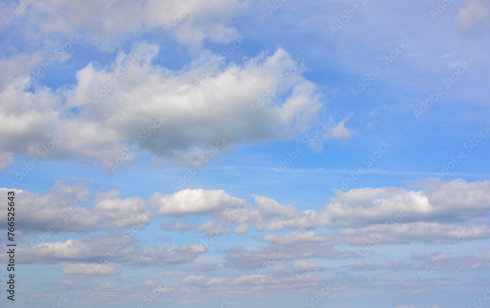 a sky with clouds and a blue sky with a few clouds  