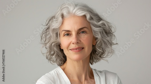 Portrait of happy senior woman smiling at home. Old man relaxing Portrait of elderly woman enjoying retirement. isolated on gray background, with copy space. white shirt