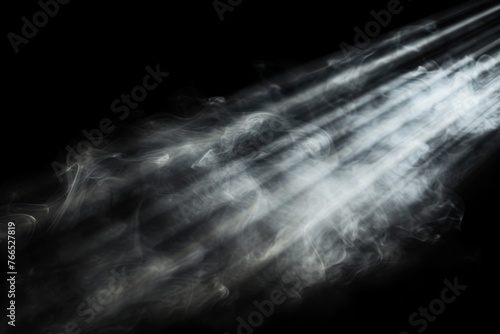 White smoke or cloud with light rays or sunbeams on black background