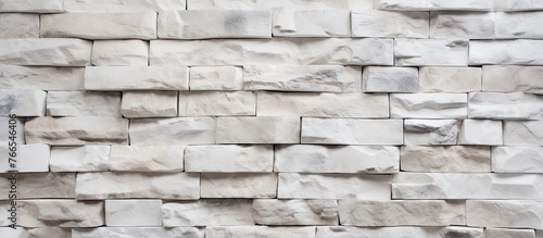 A detailed view of a white brick wall showcasing the intricate pattern of rectangular composite material. The brickwork contrasts with shades of brown, grey, and beige