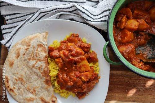 chicken curry with yellow rice and roti. Cape Malay curry © Adrian