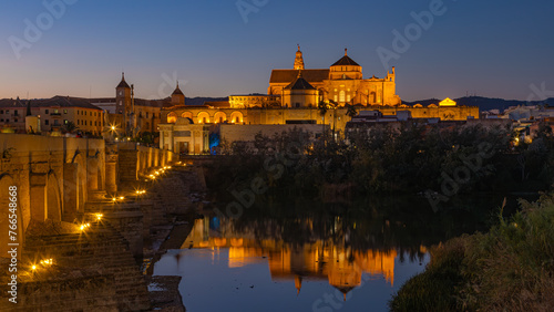 The Roman Bridge and the La Mesquita Mosque  Cathedral in Cordoba, Andalusia, Spain at Twilight Long Exposure photo