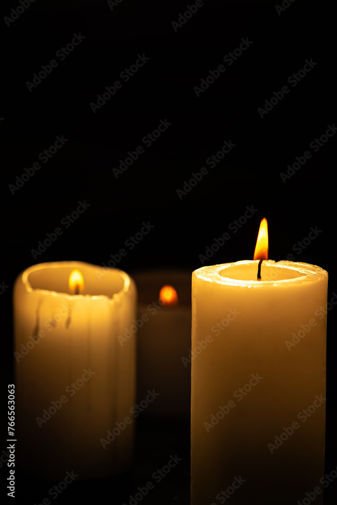 Candles, beautiful candles positioned on dark surface, black background, selective focus. Candles, beautiful candles positioned on dark surface, black background, selective focus.