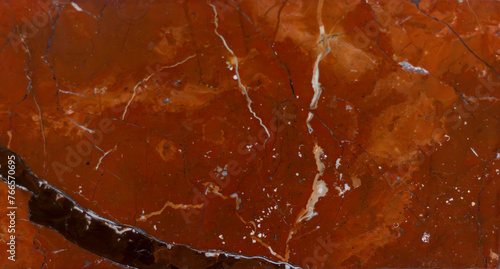 red marble texture with black veins and white splashes close-up