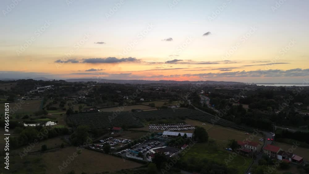Aerial drone view of the sunset passing over the mountains and a city in the distance Aerial drone view of the sunset passing over the mountains and a city in the distance