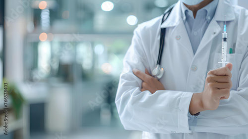 doctor holds a syringe on white blurred hospital background