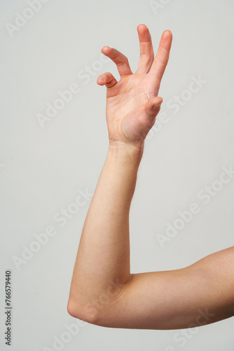 Male hand gestures over gray background studio shot