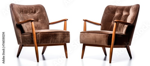 Two elegant armchairs in a mid century design featuring stylish arms and legs, perfect for a chic interior