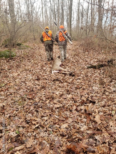 Hunters Dragging a Deer Through the Woods