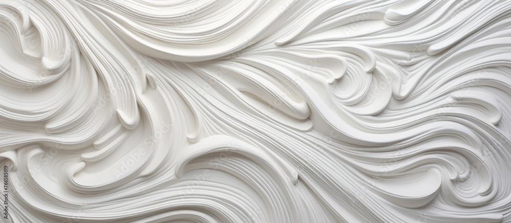 A detailed close up of a white wall featuring a very large and artistic swirl design