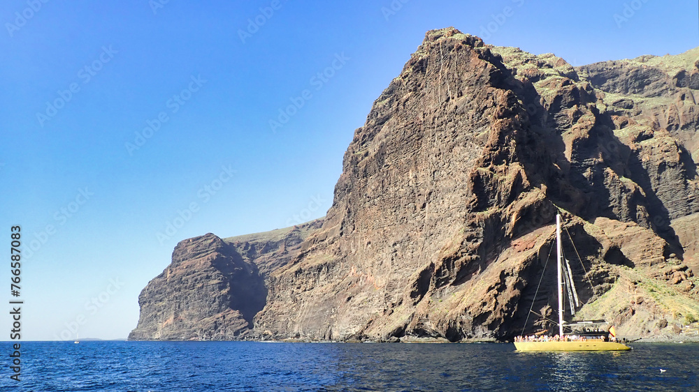 sailing at sea with a catamaran towards the collosal rocks of Los Gigantos in Tenerife