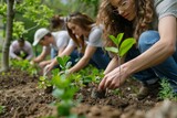 Volunteers participate in a community tree planting event, nurturing young plants and contributing to urban greenery with focused attention and care.