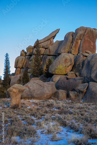 Boulder fields of Vedauwoo in Wyoming. Sherman Granite boulders in Medicine Bow -Routt National Park. Vedauwoo boulders in afternoon sun with dark blue sky and scrub trees. photo