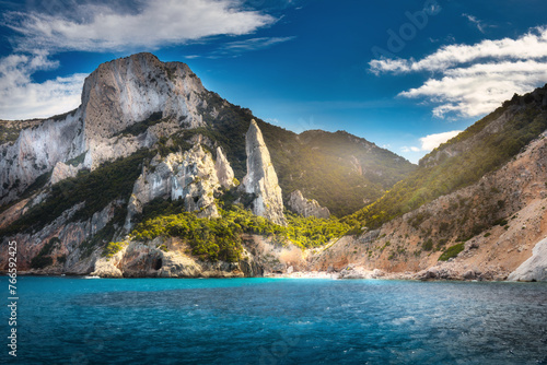 Cala Goloritze, Orosei Gulf, East Sardinia, Italy. Summer sea landscape background. Aerial view of seascape with beautiful stone coastline and beach at sunset on sunny day