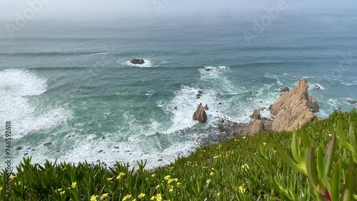 Granite boulders and sea cliffs at Cabo da Roca, westernmost point of Europe in Sintra-Cascais National Park, Portugal. photo