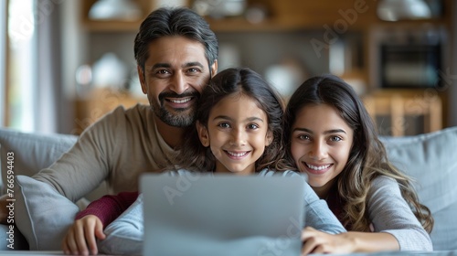 Happy indian family with child daughter with laptop © KRIS