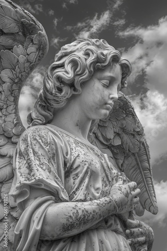 A striking black and white image of an angel statue. Perfect for adding a touch of elegance to any project