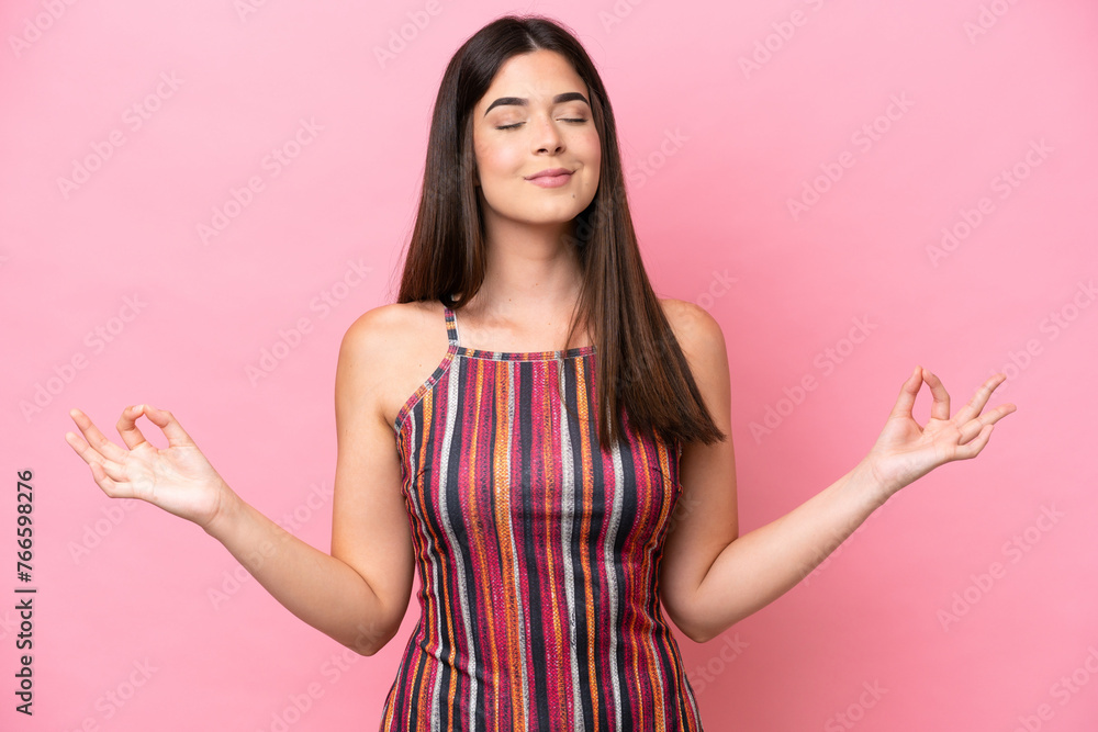 Young Brazilian woman isolated on pink background in zen pose Young Brazilian woman isolated on pink background in zen pose