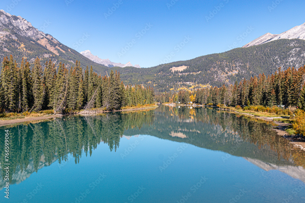 Reflections on the Bow River in the mountains
