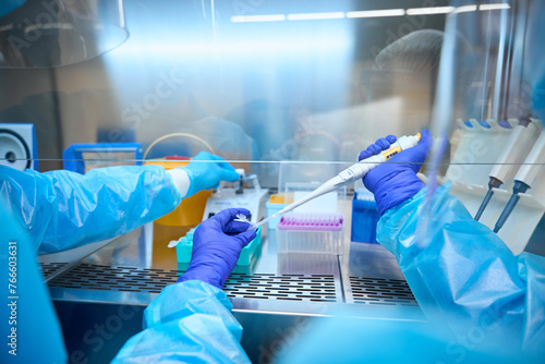 Infectious disease specialists analyze biomaterial in a sterile room © Viacheslav Yakobchuk