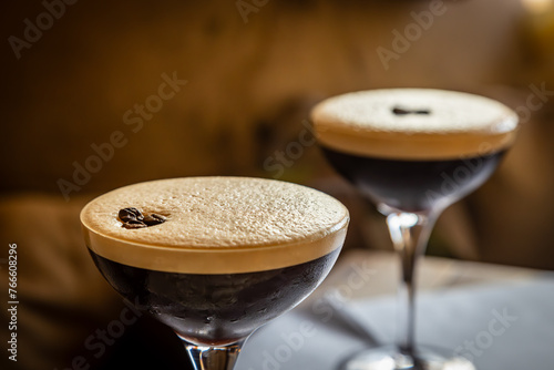 A close up of two Espresso Martini drinks, with focus on foreground