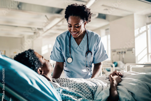 African American nurse providing care and comfort to an elderly patient in a brightly lit hospital ward, symbolizing empathy in healthcare.

 photo
