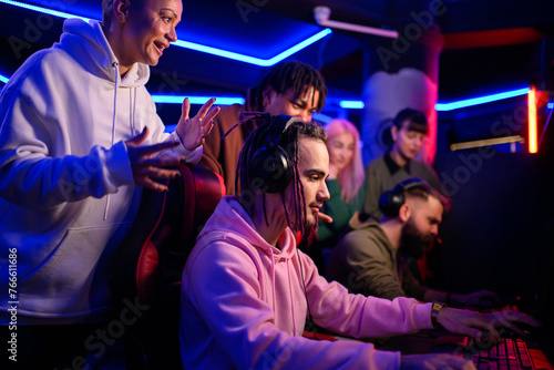 Pro eSports gamer diverse team playing online strategy video game in a gameroom photo
