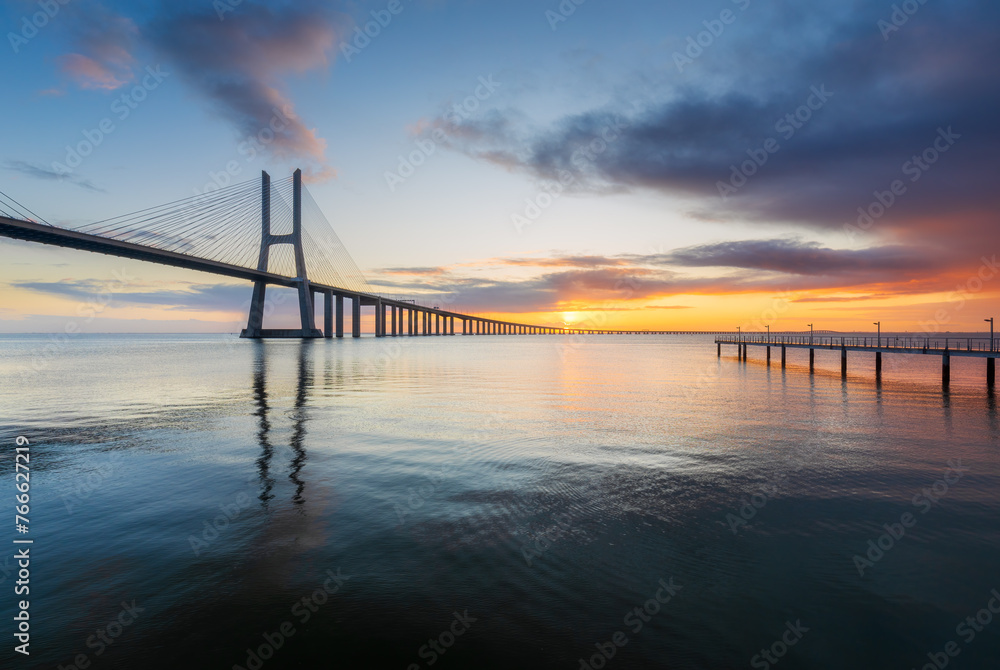 Vasco da Gama bridge and pier over tagus river in Lisbon (Portugal), at sunrise