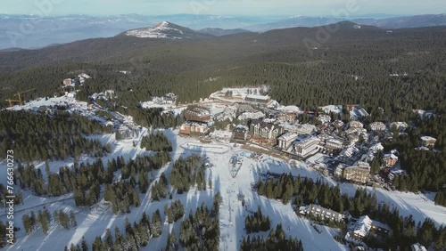 Travel and winter adventure concept. Aerial view of the ski resort. Kopaonik National Park, winter landscape in the mountains, coniferous forest covered with snow