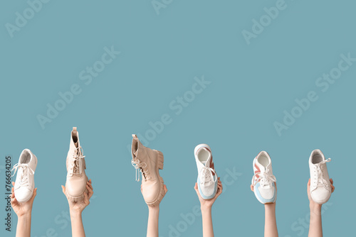 Hands holding various footw...