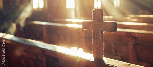 Quiet Sanctuary: Wooden Cross on Church Pews in Soft Light photo